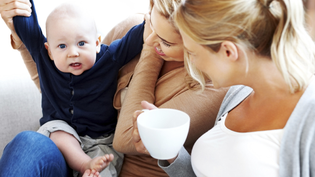 Lesbian couple with their kid having fun at home