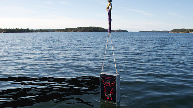 The Singing Sailor being lowered into the ocean.