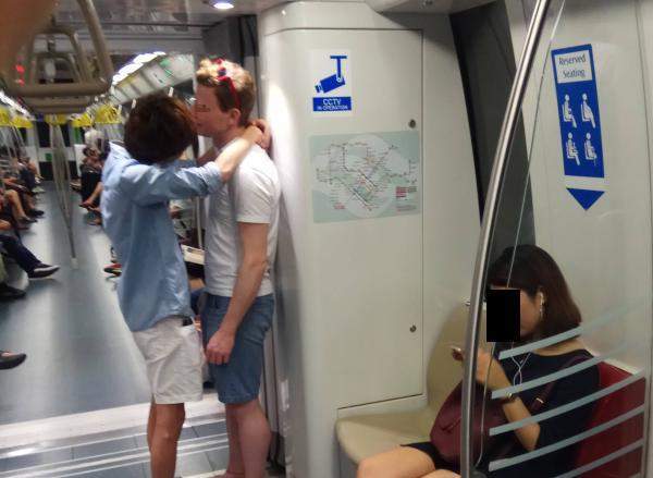 men kissing singapore train