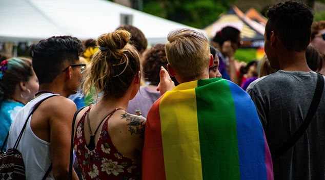 young people pride flag backs of heads