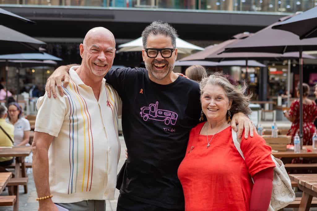 Dr Fergus McCabe is pictured flanked by two of his patients who are also active HIV community members.